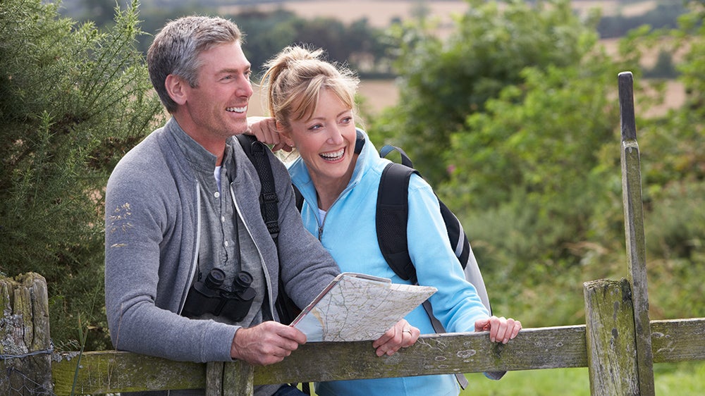 Couple hiking holding a map