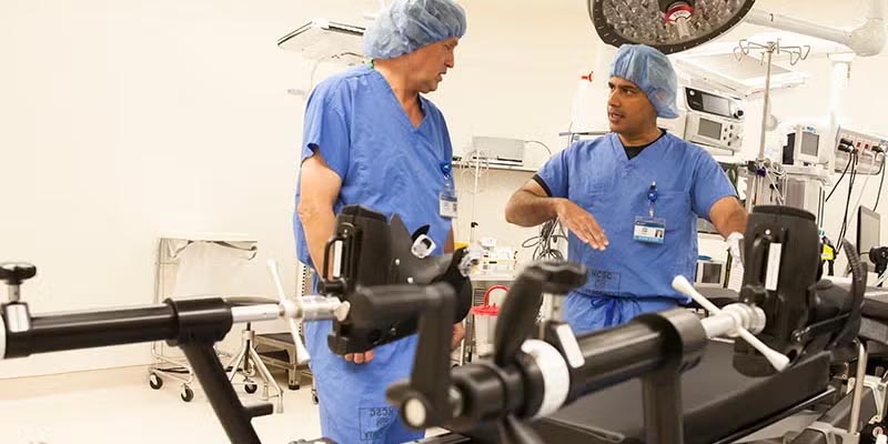 Two Doctors talking next to medical equipment