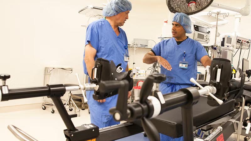 Two Doctors talking next to medical equipment