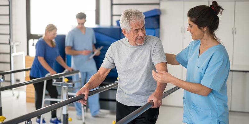 Doctor helping patient with physical therapy