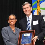 Carmela Coyle, MHA President & CEO, presents Kevin Sexton, President & CEO of Holy Cross Hospital with MHA's Distinguished Service Award.